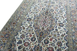 Backside of handmade 2000s Kashan rug showing knot structure and weave density