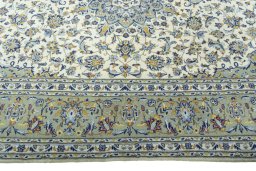Corner detail of 2000s Kashan rug showing border pattern and Cork pile