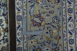 Backside of handmade 2000s Kashan rug showing knot structure and weave density