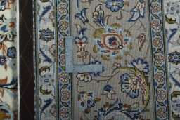 Backside of handmade 2000s Kashan rug showing knot structure and weave density