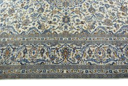 Corner detail of 2000s Kashan rug showing border pattern and Wool pile