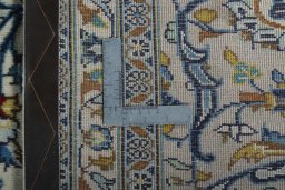 Backside of handmade 2000s Kashan rug showing knot structure and weave density