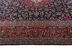 Corner detail of 2000s Kashan rug showing border pattern and Wool pile