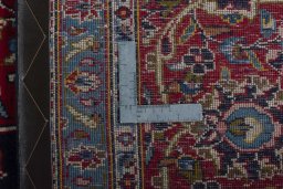 Backside of handmade 2000s Kashan rug showing knot structure and weave density