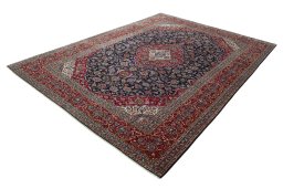 Corner detail of 2000s Kashan rug showing border pattern and Wool pile