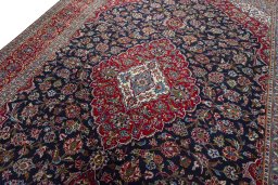 Backside of handmade 2000s Kashan rug showing knot structure and weave density