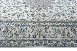 Corner detail of 2000s Kashan rug showing border pattern and Wool pile