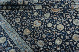 Close-up detail of 2000s Kashan rug from Iran / Persia showing Wool weave