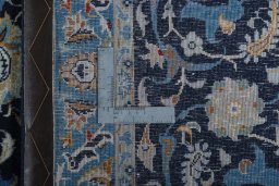Backside of handmade 2000s Kashan rug showing knot structure and weave density