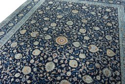 Backside of handmade 2000s Kashan rug showing knot structure and weave density