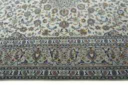 Corner detail of 2000s Kashan rug showing border pattern and Wool pile