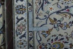 Backside of handmade 2000s Kashan rug showing knot structure and weave density