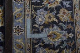 Backside of handmade 1970s Kashan rug showing knot structure and weave density