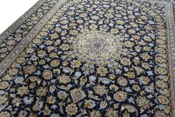 Backside of handmade 1970s Kashan rug showing knot structure and weave density