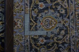 Backside of handmade 2000s Kashan rug showing knot structure and weave density