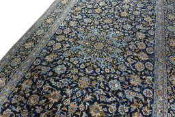 Backside of handmade 2000s Kashan rug showing knot structure and weave density