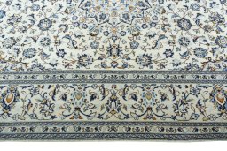 Corner detail of 2000s Kashan rug showing border pattern and Wool pile