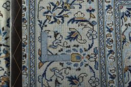 Backside of handmade 2000s Kashan rug showing knot structure and weave density