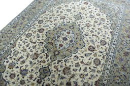Backside of handmade 2000s Kashan rug showing knot structure and weave density