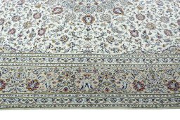Corner detail of 2000s Kashan rug showing border pattern and Wool pile