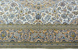 Corner detail of 2000s Kashan rug showing border pattern and Wool pile