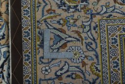 Backside of handmade 2000s Kashan rug showing knot structure and weave density