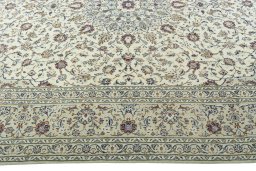 Corner detail of 2000s Kashan rug showing border pattern and Wool pile
