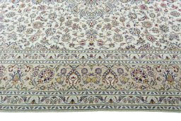 Corner detail of 2000s Kashan rug showing border pattern and Wool pile