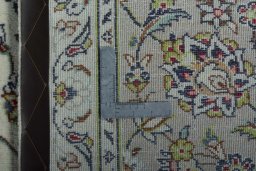 Backside of handmade 2000s Kashan rug showing knot structure and weave density