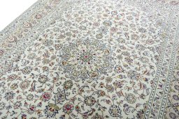 Backside of handmade 2000s Kashan rug showing knot structure and weave density