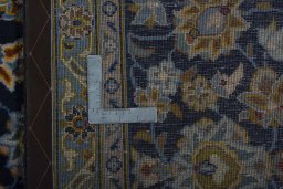 Backside of handmade 1970s Kashan rug showing knot structure and weave density