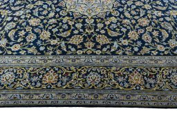 Corner detail of 2000s Kashan rug showing border pattern and Wool pile