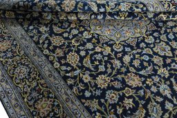 Close-up detail of 2000s Kashan rug from Iran / Persia showing Wool weave