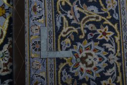 Backside of handmade 2000s Kashan rug showing knot structure and weave density