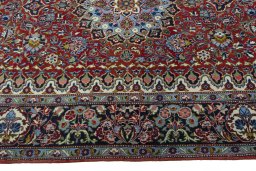 Corner detail of 2000s Kashan rug showing border pattern and Cork pile