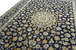 Backside of handmade 2000s Kashan rug showing knot structure and weave density