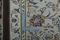 Backside of handmade 2000s Kashan rug showing knot structure and weave density