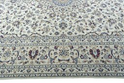 Corner detail of 2000s Kashan rug showing border pattern and Wool pile