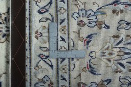 Backside of handmade 2000s Kashan rug showing knot structure and weave density