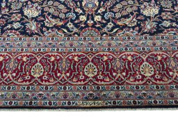 Corner detail of 2000s Kashan rug showing border pattern and Wool pile
