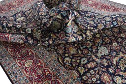 Backside of handmade 2000s Kashan rug showing knot structure and weave density