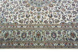 Corner detail of 2000s Kashan rug showing border pattern and Wool pile