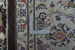 Backside of handmade 2000s Kashan rug showing knot structure and weave density