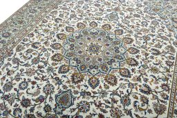 Backside of handmade 2000s Kashan rug showing knot structure and weave density