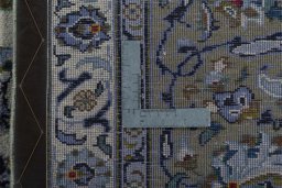 Backside of handmade 2000s Kashan rug showing knot structure and weave density