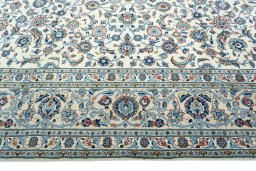 Corner detail of 2000s Kashan rug showing border pattern and Wool pile