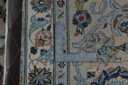 Backside of handmade 2000s Kashan rug showing knot structure and weave density