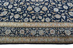 Corner detail of 2000s Kashan rug showing border pattern and Wool pile