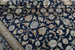 Close-up detail of 2000s Kashan rug from Iran / Persia showing Wool weave