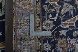 Backside of handmade 2000s Kashan rug showing knot structure and weave density